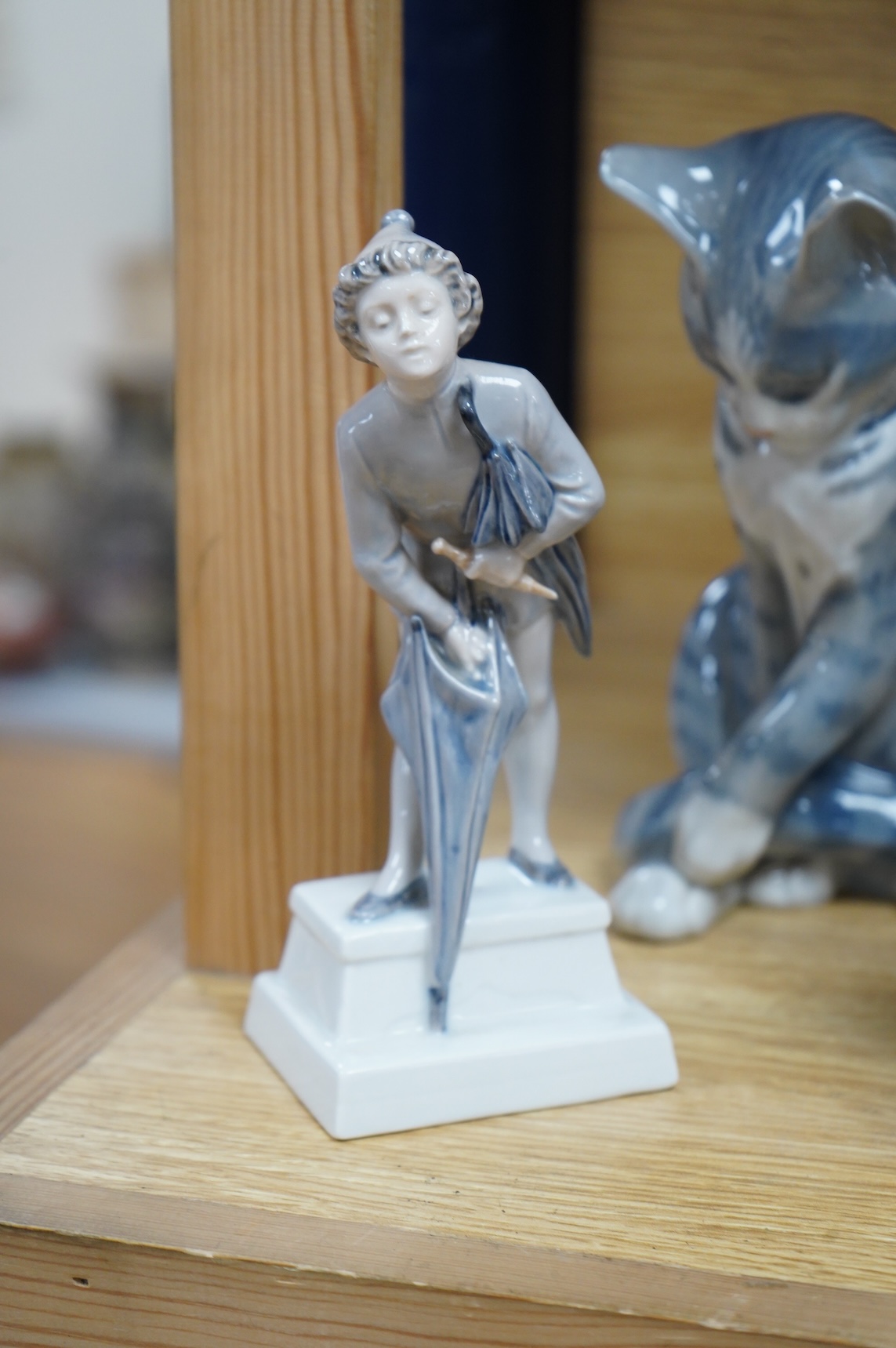 A Royal Copenhagen figure, 'The Sandman', Number 1129, a similar cat, number 340, a B&G spaniel and a Danish lion, tallest 18.5cm